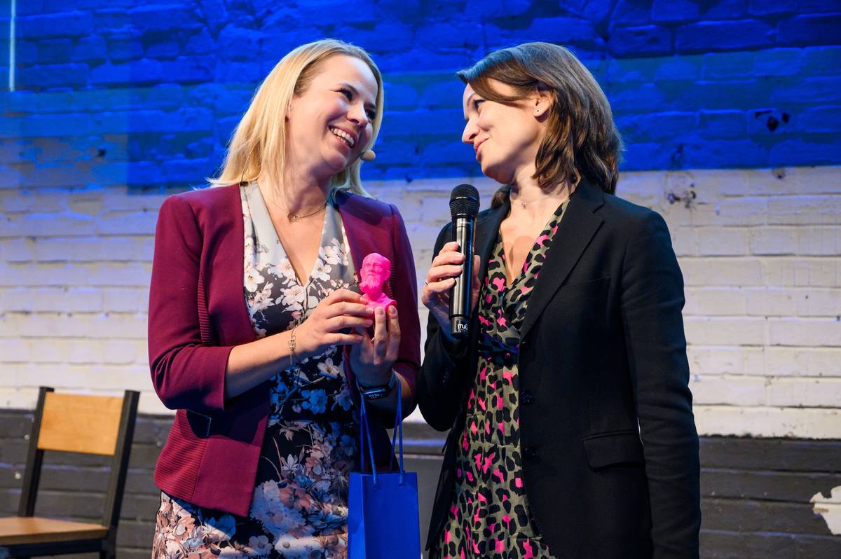 Barbara Zelenay interviewing a guest during an event